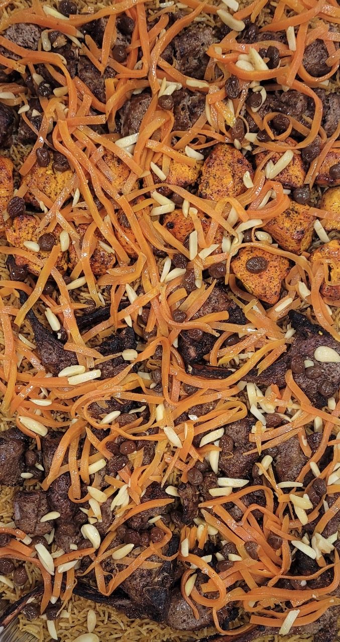 Platter for 8 people — kabobs over rice with carrots, raisins, and almonds